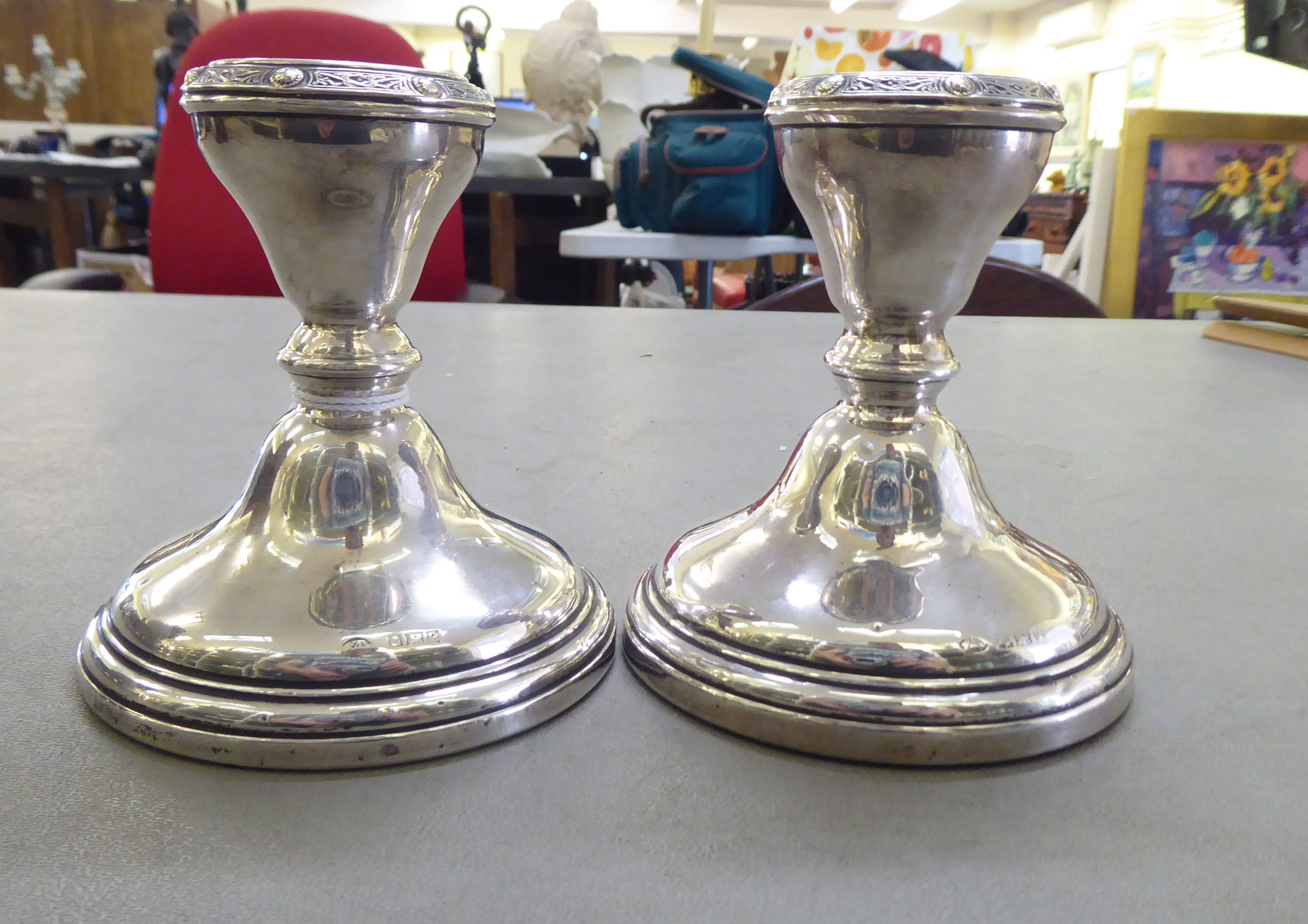 A pair of silver dwarf candlesticks, each with a Celtic design sconce  Birmingham marks rubbed  4"h