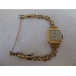 A lady's 9ct gold cased Binesa wristwatch, the square face set with an Arabic dial