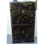 A modern Chinese inspired black lacquered and overpainted cabinet, comprising four doors and two