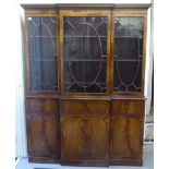 A 20thC Georgian design mahogany two part breakfront bookcase, the upper section with three glazed