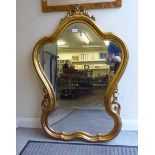 A modern Rococo design mirror, in a gilt frame  40" x 28"