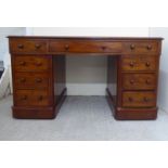A late Victorian mahogany nine drawer, twin pedestal desk, on a plinth  29"h  56"w