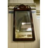 A 19thC mirror, the plate set in a crossbanded mahogany frame with a fretworked crest  27" x 13"