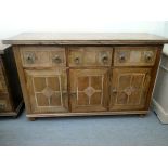 A modern fruitwood and marquetry sideboard with three drawers and three cupboard doors, raised on