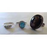 Three silver coloured metal dress rings: to include one set with an oval citrine