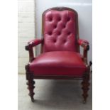 A late Victorian mahogany showwood framed open arm salon chair, stud upholstered in red hide, raised