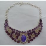 A silver Alexandrite and clear stone necklace