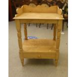 A late Victorian stained pine washstand, the raised back set with tiles and a frieze drawer,