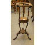 An early 19thC mahogany washstand, the top with a circular aperture, over a triangular box drawer,