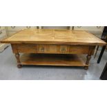 A modern fruitwood and marquetry coffee table with a frieze drawer, raised on turned legs, united by