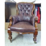 A late Victorian mahogany showwood framed salon chair with a part button and stud upholstered