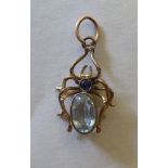 An antique 9ct gold aquamarine and sapphire set spider pendant