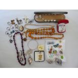Items of personal ornament: to include an amber coloured necklace; a Danish porcelain tablet pendant