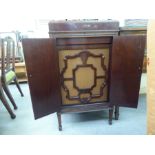 A Decca Salon freestanding mahogany cased gramophone with a hinged lid and sound box, raised on