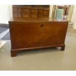 A George III mahogany chest with straight sides and cast brass flank bail handles and a hinged