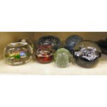 Seven decorative glass paperweights: to include a Caithness example