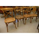 A set of four early 20thC unpainted bentwood style dining chairs with crossover splats and woven