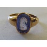 A yellow metal intaglio carved sapphire signet ring