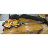 A Shine three-quarter size violin style bass guitar, in a soft carrying case