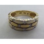 A 14ct gold three band ring, set with diamonds