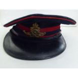 A peaked cap  bearing a military badge  (Please Note: this lot is subject to the statement made in
