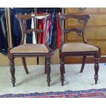 A pair of early Victorian mahogany framed bar back chairs, the fabric upholstered seats raised on