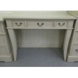 A modern cream painted side table with three drawers, raised on square, tapered, splayed legs  30"h