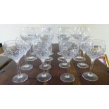 A set of eight Stuart crystal pedestal wines; and eight smaller, each with line-cut decoration