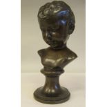 A late 19thC cast and patinated bronze bust, a young boy, on a turned socle  11.5"h