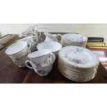 A Royal Worcester bone china tea set, decorated with gilt banding and overpainted with floral and