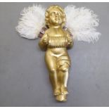 A vintage gilt painted, carved wooden standing cherub, adorned with white feathers  19"h