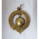 A gold coloured metal football themed pendant  stamped 10k