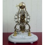 A mid 20thC lacquered brass skeleton clock; the single fusee movement faced by a Roman dial, on a