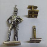 A pair of silver gilt tablet design cufflinks; and a silver model 19thC soldier  3"h  mixed marks