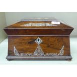 A Regency mother-of-pearl inlaid rosewood sewing box of sarcophagus form, the hinged lid enclosing a