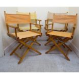 A set of four beech framed director's chairs with peach/cream coloured canvas backs and seats