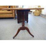An early 19thC mahogany, rectangular tip-top pedestal table, raised on a splayed tripod base  27"