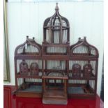 A Victorian style brown wash painted wood and wire birdcage with a triple dome top  32"h  27"w  7"