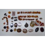 A collection of amber coloured beads and similar items of personal ornament