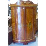 A 19thC style Anglo-Indian standing, two door quadrant cupboard with painted decoration and a