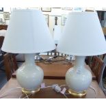 A pair of Ralph Lauren cream coloured and gilded ceramic bottle vase design table lamps and