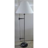 A Ralph Lauren matt black standard lamp with a transparent cylindrical stem and shade  61"h overall