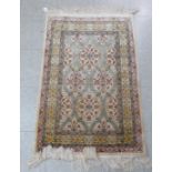 A Persian part silk rug, decorated in colours with floral designs  42" x 28"