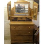 An early 20thC pine dressing table, surmounted by a triptych mirror, over three drawers, raised on