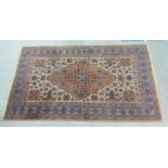 A Persian design rug, decorated with geometric patterns, on a cream ground  82" x 46"
