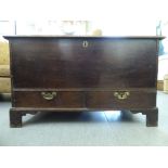 A late 19thC oak chest with two base drawers and brass bale handles and a lockable hinged lid,