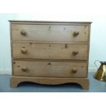 A 1920s waxed pine three drawer dressing chest with bun handles, raised on bracket feet  32"h  36"w