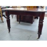 An early Victorian mahogany dining table with two additional leaves, raised on tulip carved,