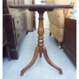 A mid 19thC mahogany pedestal table, the rectangular top over a turned column and splayed tripod