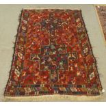 A multi-coloured woollen rug, decorated with naively designed animals and figures  62" x 40"